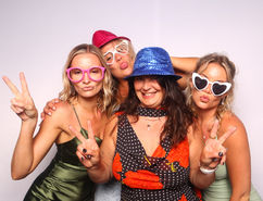 Four women using a photo booth hire Queenstown service.