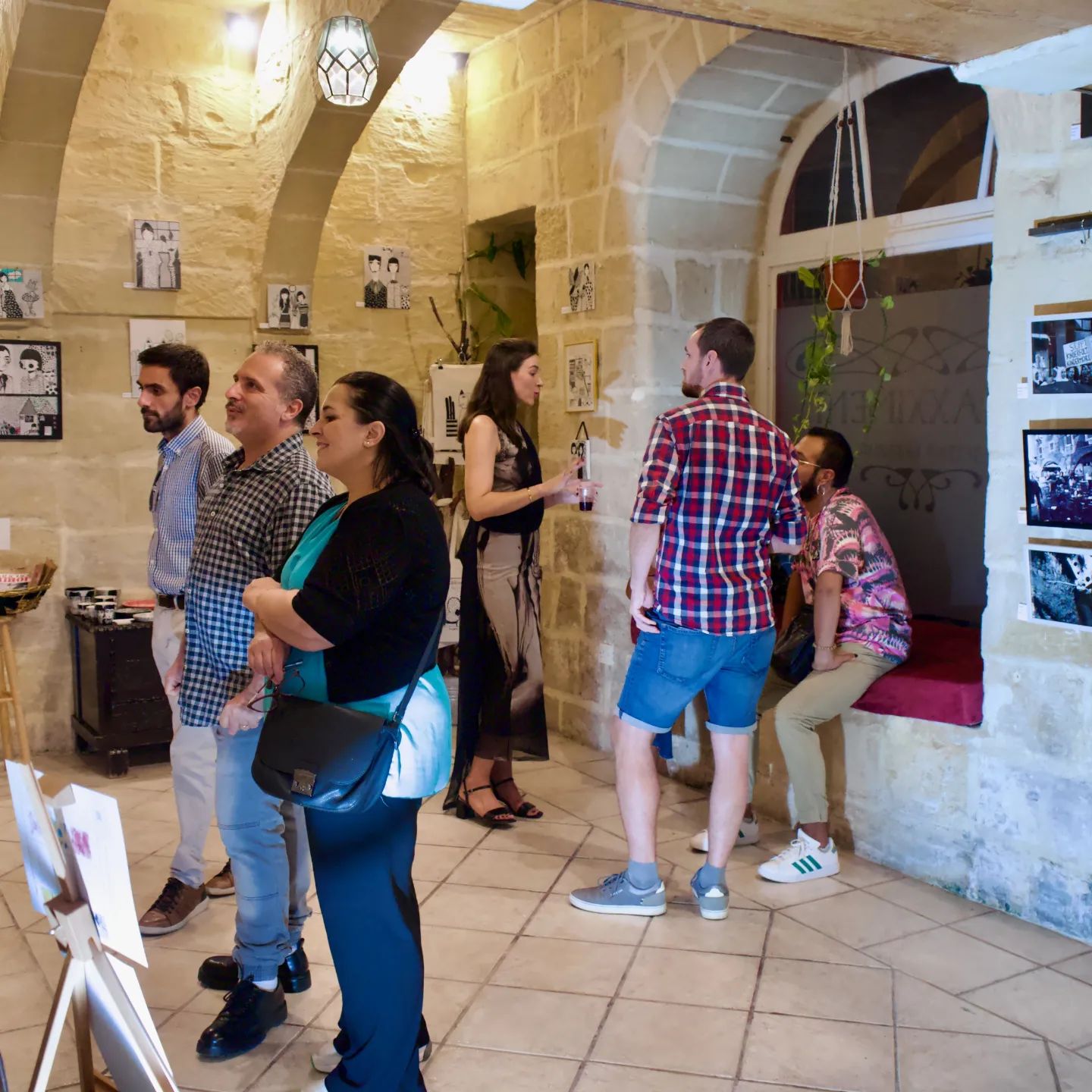 Enjoying the exhibition and speaking with the artist about the original artworks