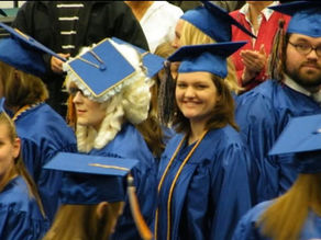 Artistic university graduates in their blue gowns and colourful tassels