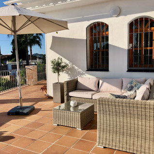 SEATING GROUP ON MAIN LEVEL. The umbrella will give some shade on hot summer days.
