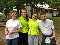 Group of four campers and staff with hand lettering on t-shirts