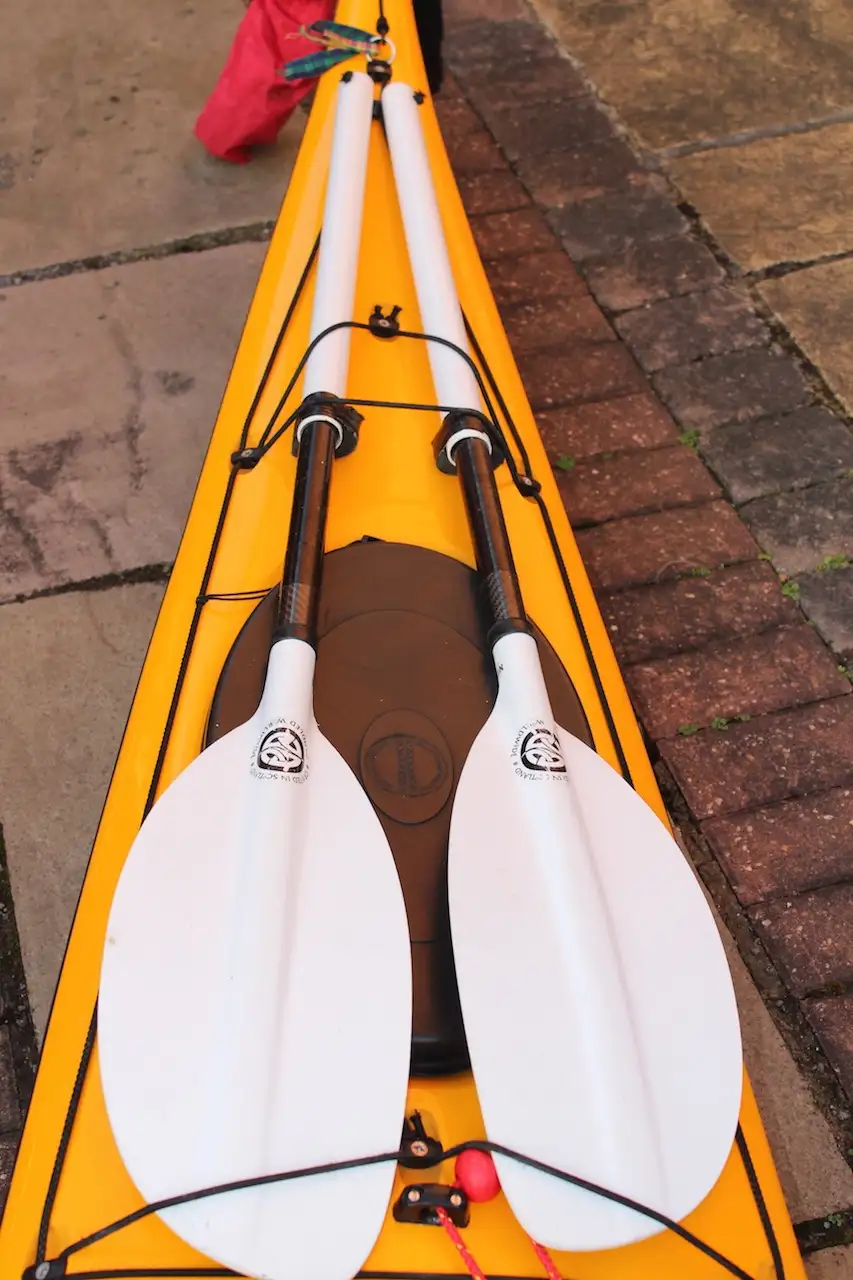 Common placement for spare sea kayak paddle