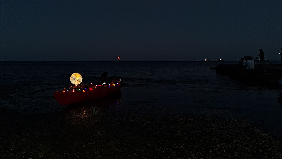 The Sturgeon Supermoon rising from the sea with Frenki's kayak in the foreground