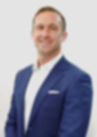 Nick Headley, President and Founder of Latitude DST Group, wearing a blue suit and smiling.
