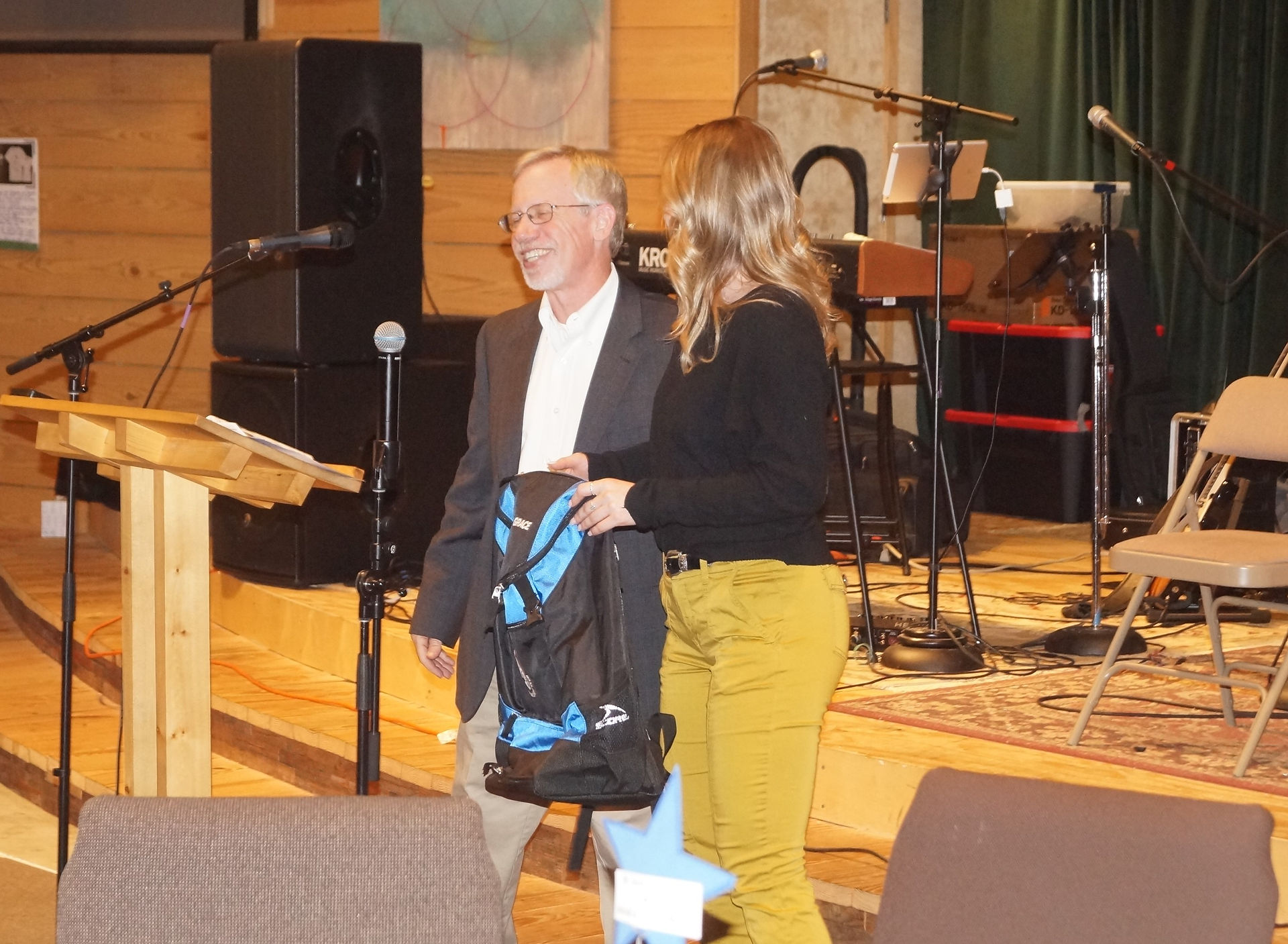 Paul Neville surprising Grace Clark with monogramed coaching bag in honor of her first season on staff.
