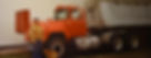 Old image of Tom Franey and his dog next to the first truck. 