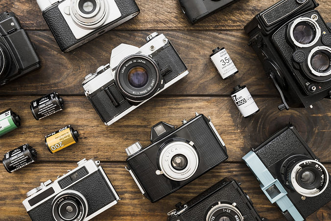 small-film-cartridges-amidst-cameras-scaled.jpg