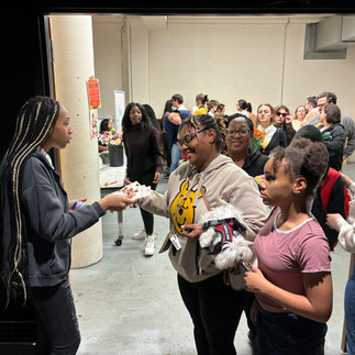 Families gather to see a play in the Kairos auditorium. 