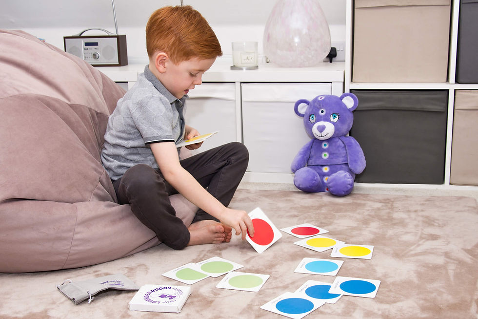 Thumbnail: Young Boy sitting on Floor using the coloured cards with affirmation and the bear is in the background nearby