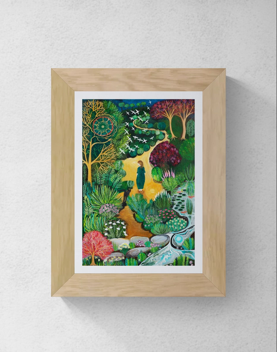 A path through a park with a woman being followed by a cat