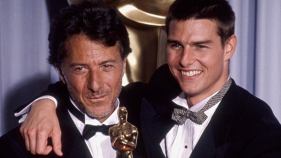 Dustin Hoffman and Tom Cruise holding Oscar for Best Actor for Rain Man at the Academy Awards, Tom Cruise with short hair filming Born on the Fourth of July.