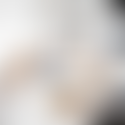 Three people playing a game at a coffee table