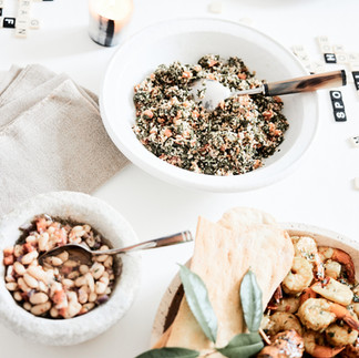 serving table with bowls of grains and beans.
