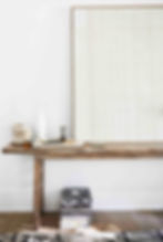 Original art from Dawn Sweitzer above a vintage console table.