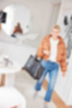 woman in puffer jacket entering a home