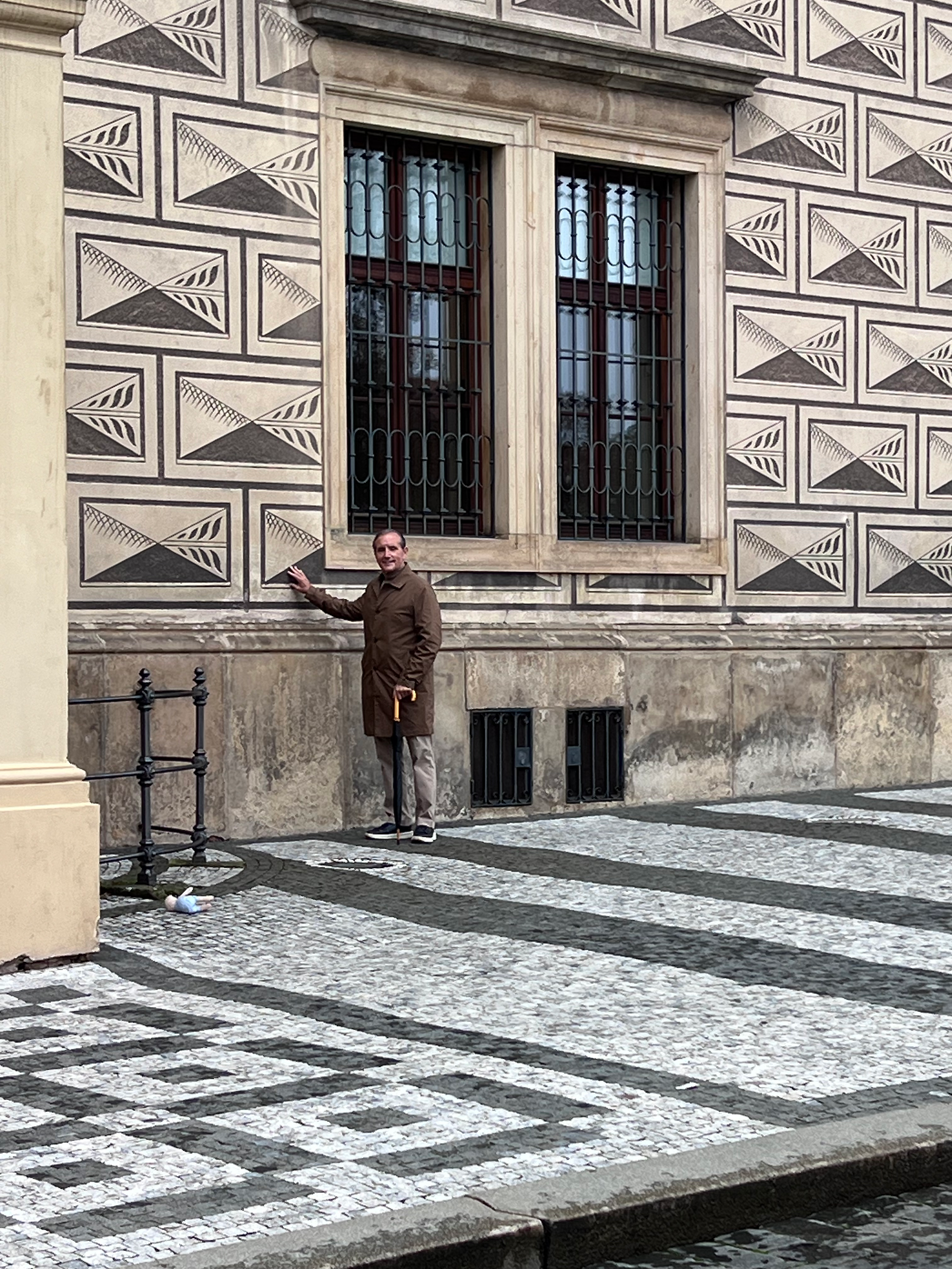 Man standing in a square with mosaics
