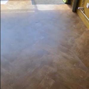 Brown textured floor with natural light reflections.