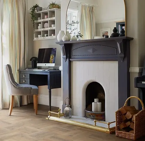 Colonia small tile LVT done in a block design in a room with a fire place and desk