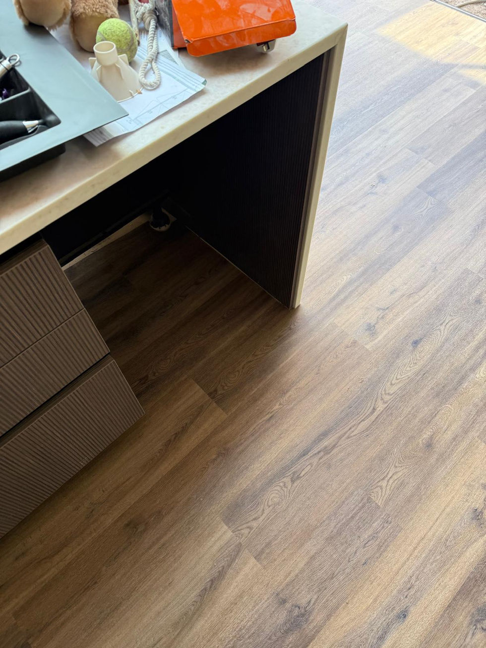 Flooring fitted around the kitchen island and units.