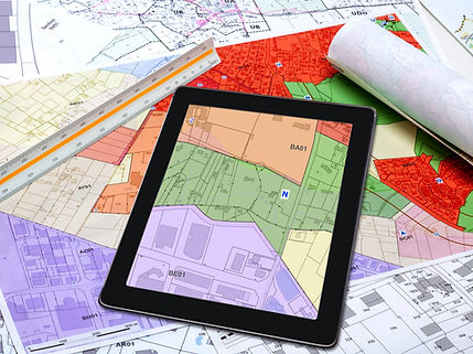 Town Planning and Land Use - digital tablet displaying a land use plan, placed on maps of