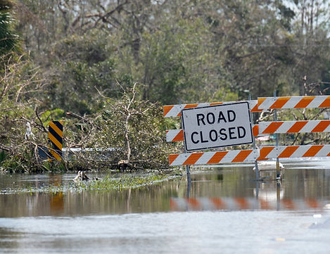 Road closed for roadworks and danger of flooding with warning signs blocking driving of ca