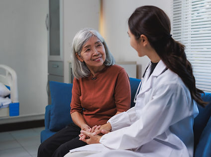 Doctor comforting elderly patient during medical consultation in hospital room.jpg