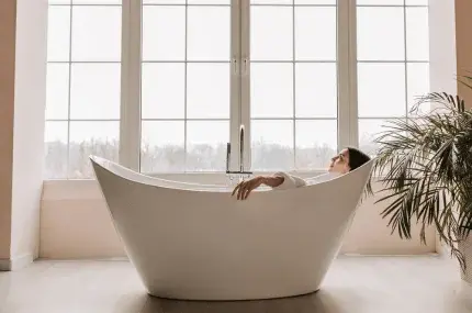woman in white freestanding bath