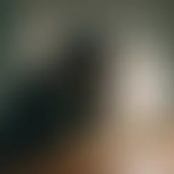 person sitting at desk at night overwhelmed by racing thoughts and anxiety