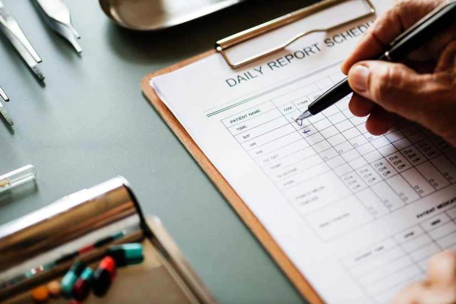 person filling up the daily report schedule form