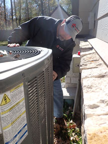 Inspector Clint inspecting air conditioner