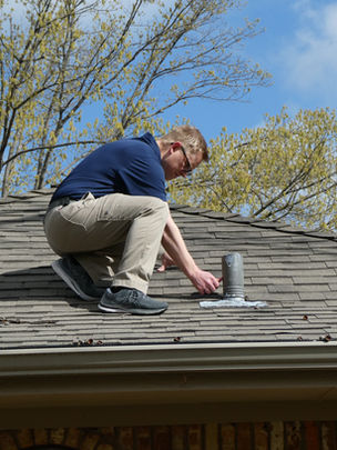 Technician inspecting roof vent