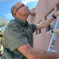 Inspector Peter Inspecting house using ladder