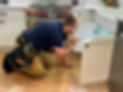 Inspecting kitchen sink plumbing for leaks and function.jpeg