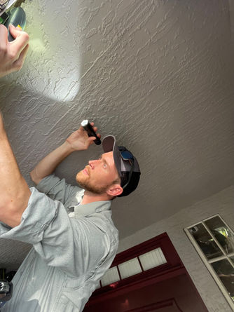 Inspector William Inspecting House using flashlight
