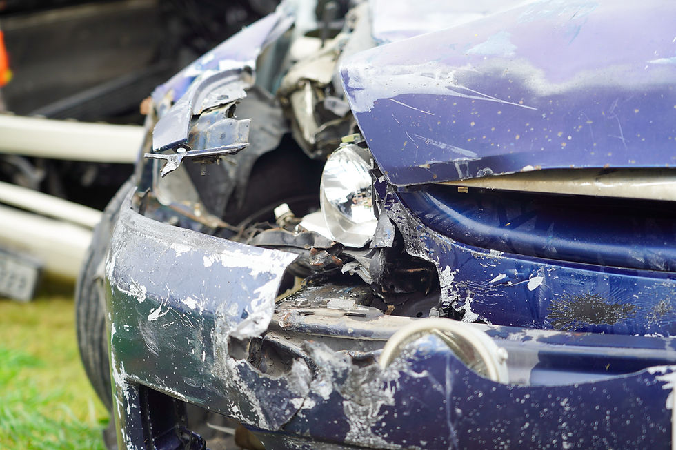 Front view of a severely damaged vehicle, showcasing extensive dents and a shattered bumper, highlighting the aftermath of a collision.