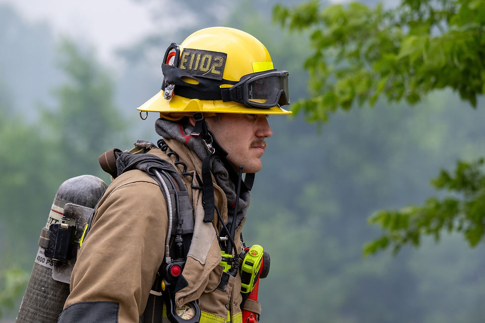 A firefighter walks towards a fire.