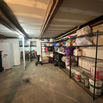 Basement storage area organized by Northstar Assembly using labeled bins and shelves