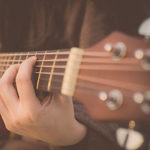 A close-up of someone playing guitar