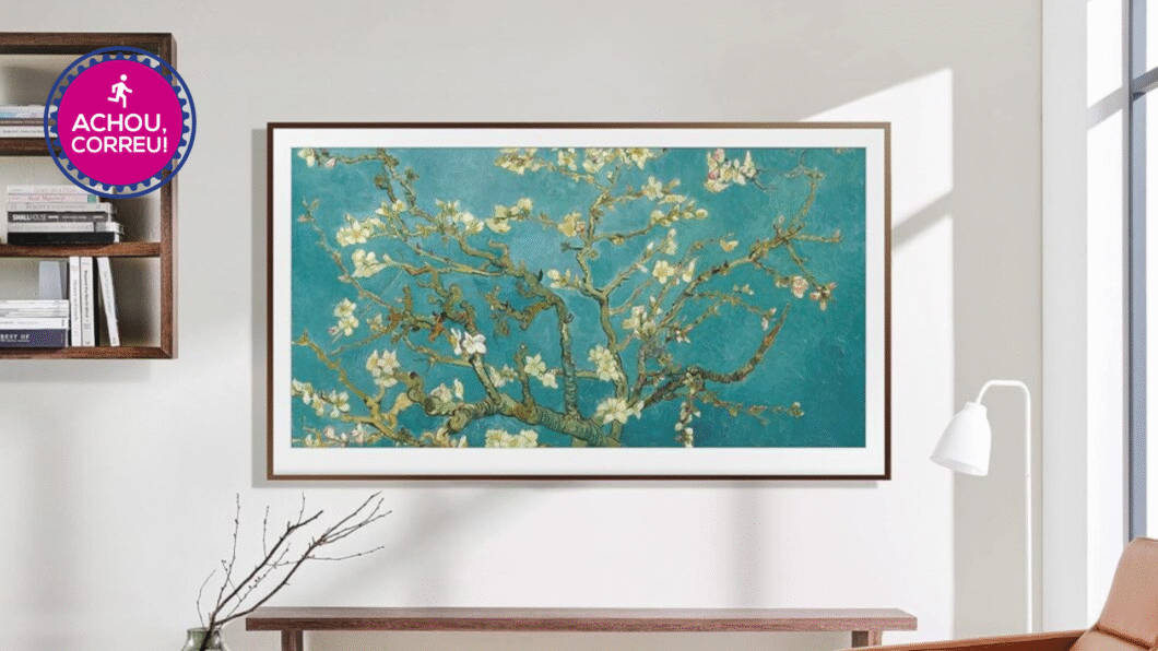 TV Samsung QLED LS03C de 32" presa na parede de cor branca e com uns móveis ao redor