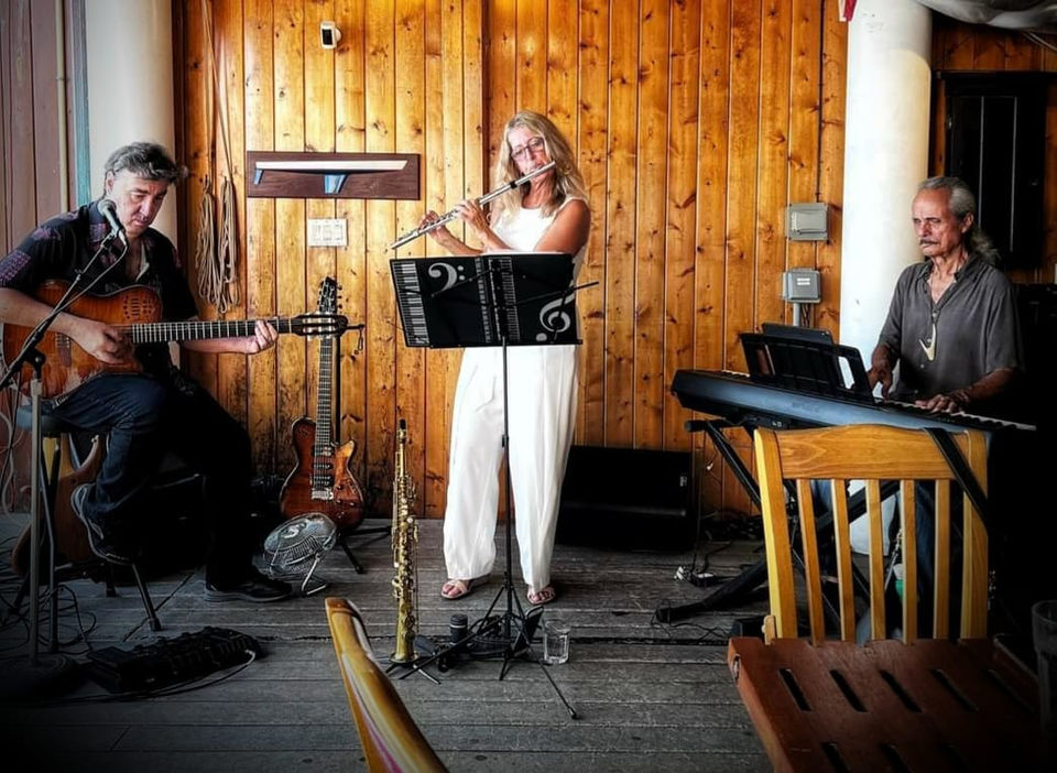 Deb playing flute at Lahaina Yacht Club
