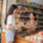 A young Vietnamese woman shopping at a traditional grocery store, representing Vietnam’s General Trade (GT) retail network that dominates the country’s FMCG market.