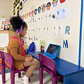 2 year old in the technology station