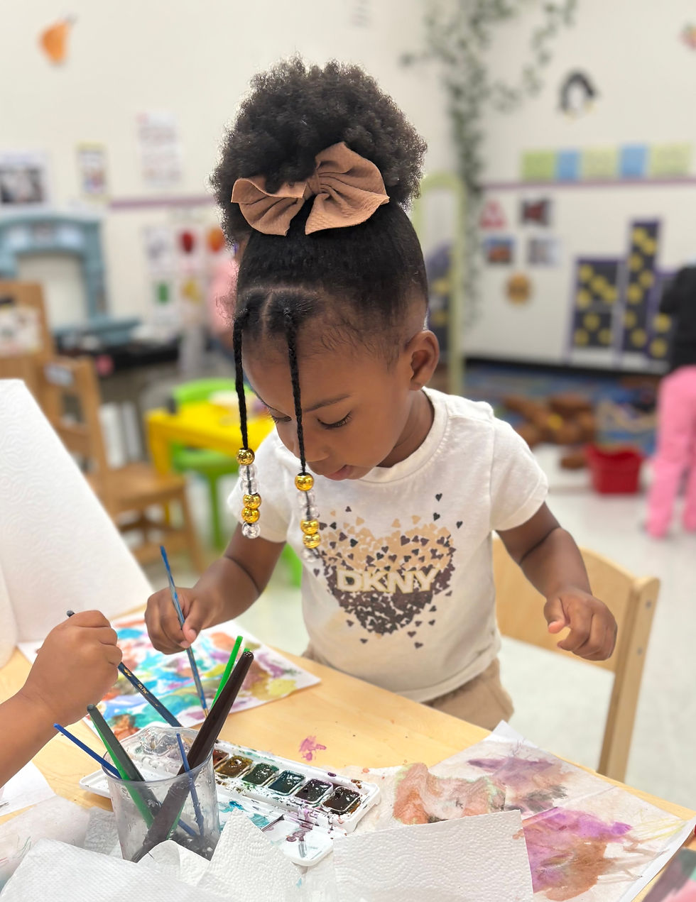 Close-up view of preschool activity table with colorful blocks and art supplies