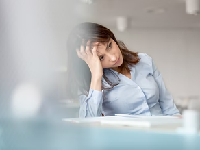 a woman tired at her desk
