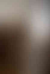 Bride looking at dress hanging up