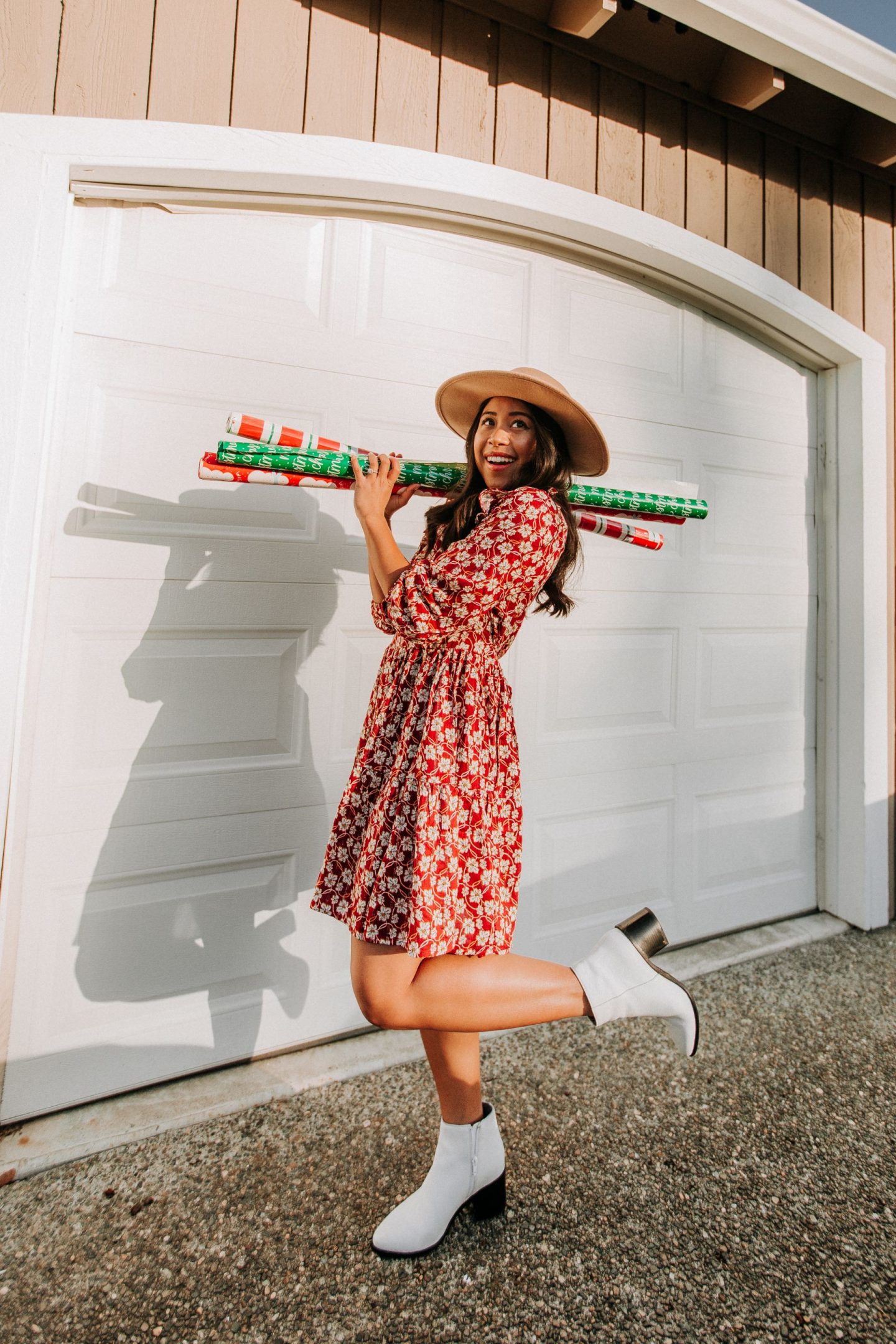 Standing in front of garage  holding holiday and christmas wrapping paper - image from www.emmasedition.com - copyright @emmasedition 