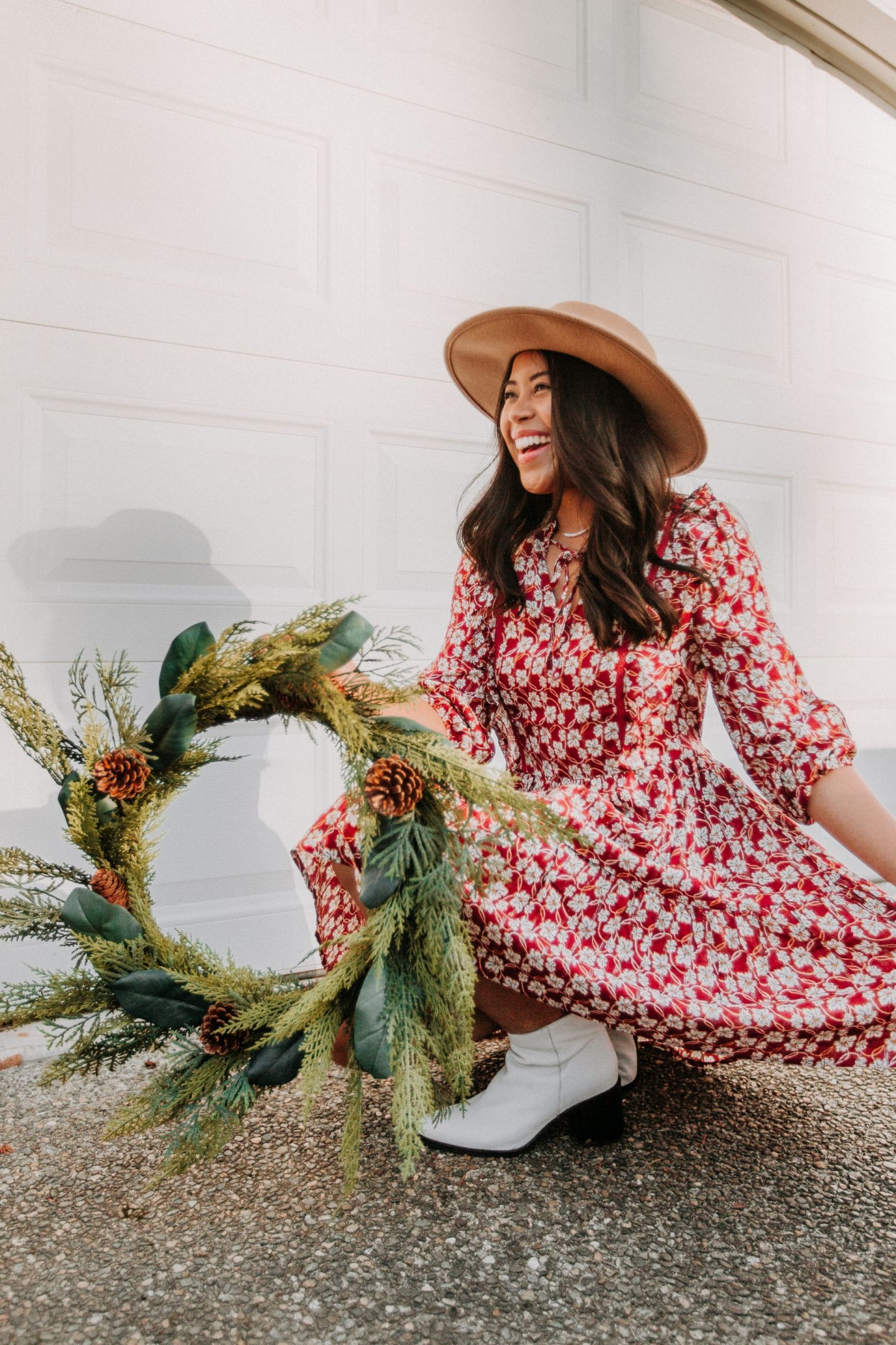 Posing in front of a garage with a wreath for a holiday photo shoot– image from www.emmasedition.com – copyright @emmasedition