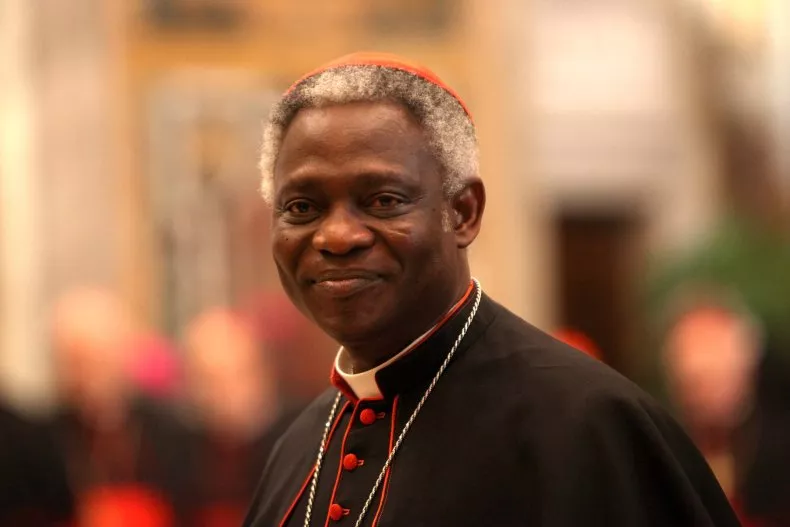Ghanaian cardinal Peter Kodwo Appiah Turkson waits to exchange Christmas greetings with Pope Francis at the Clementina Hall on December 21, 2013 in Vatican City, Vatican. Photo by Franco Origlia/Vatican Pool/Getty Images