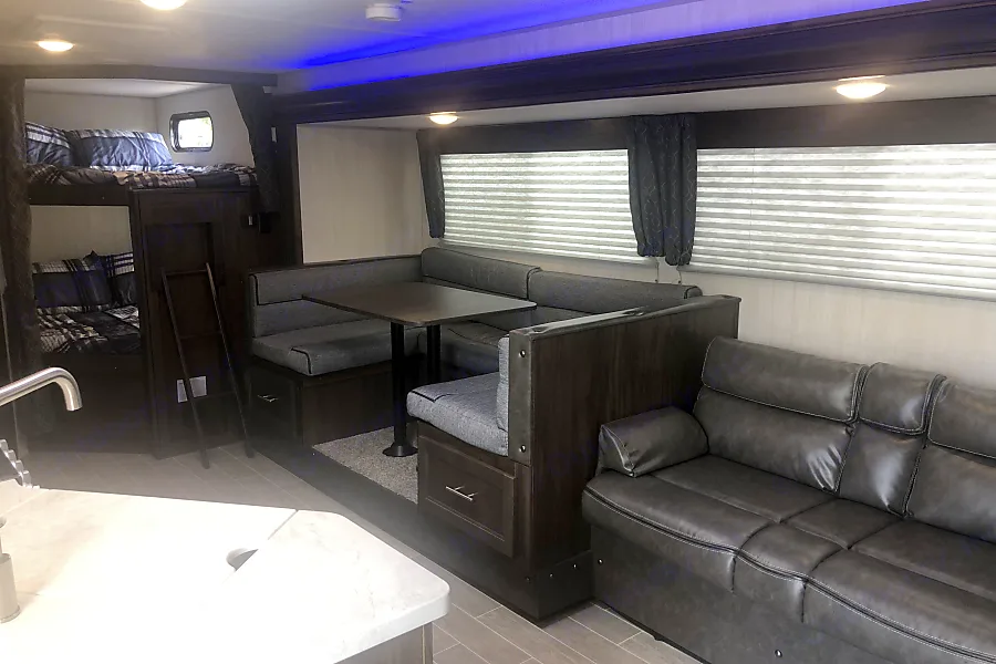 sofa with dinette and bunks in the background