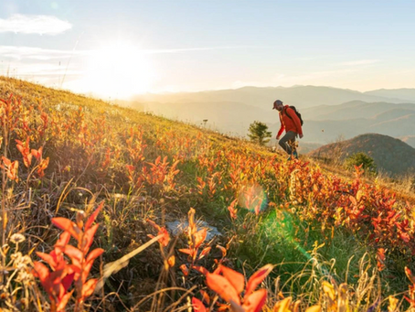 Man hiking North Carolina mountains at sunset